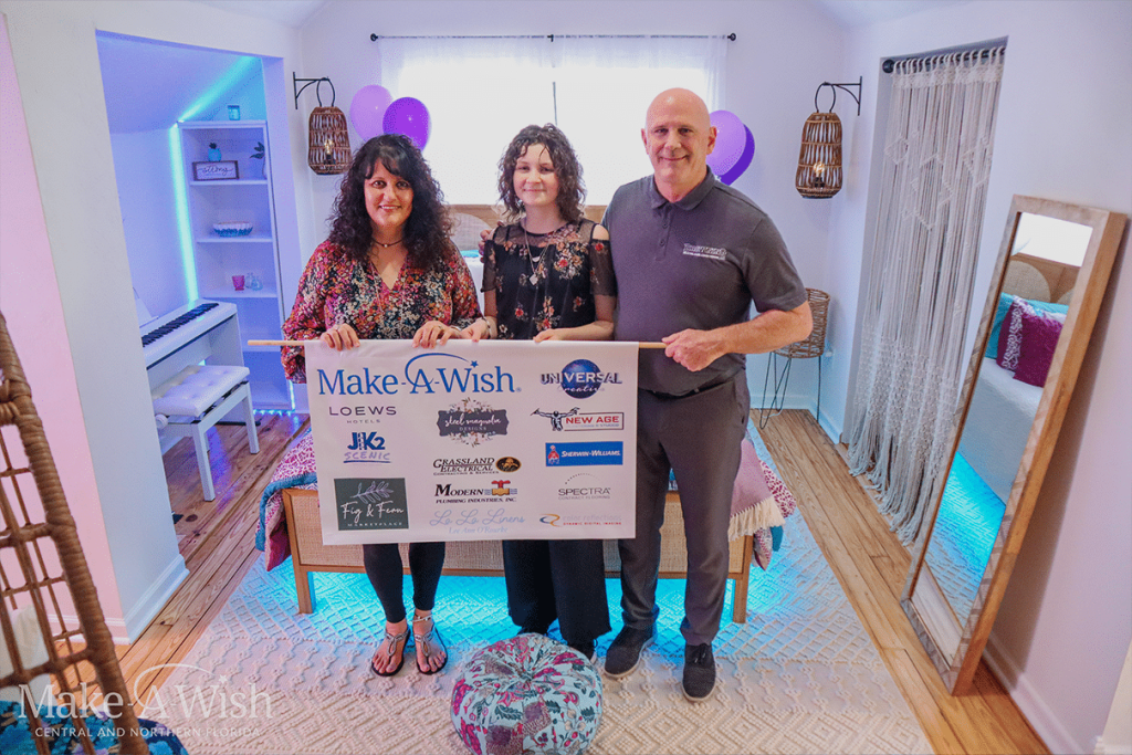 Gabriella poses with her parents in her newly decorated room