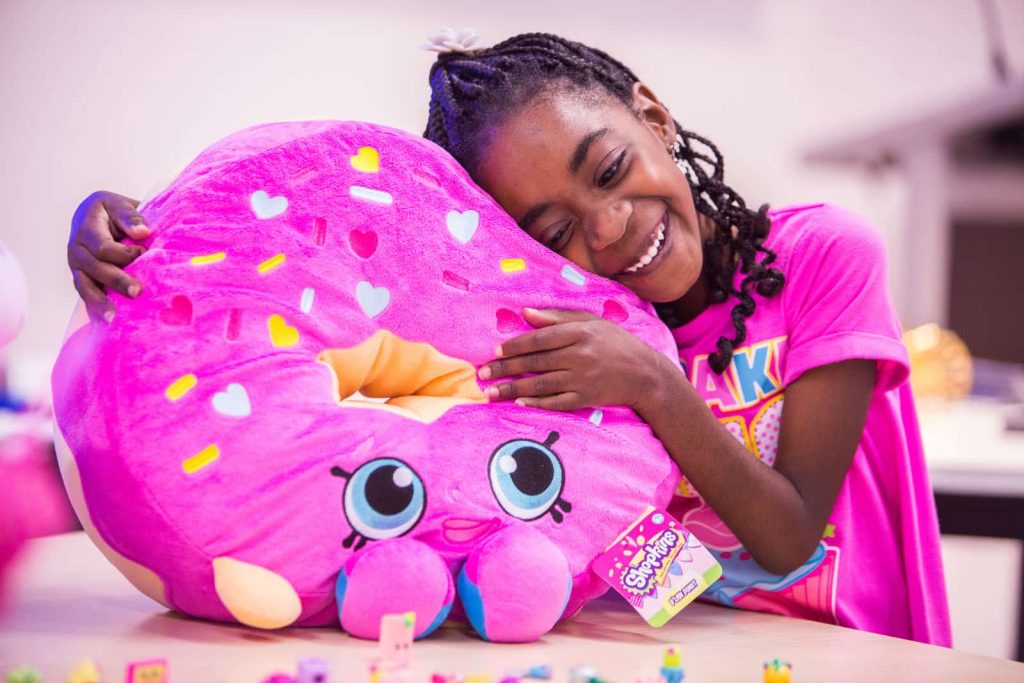 African American girl hugging a stuffed toy