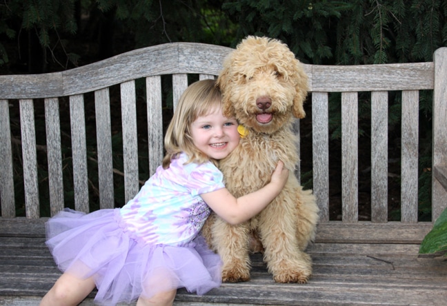 Noella hugs her new puppy