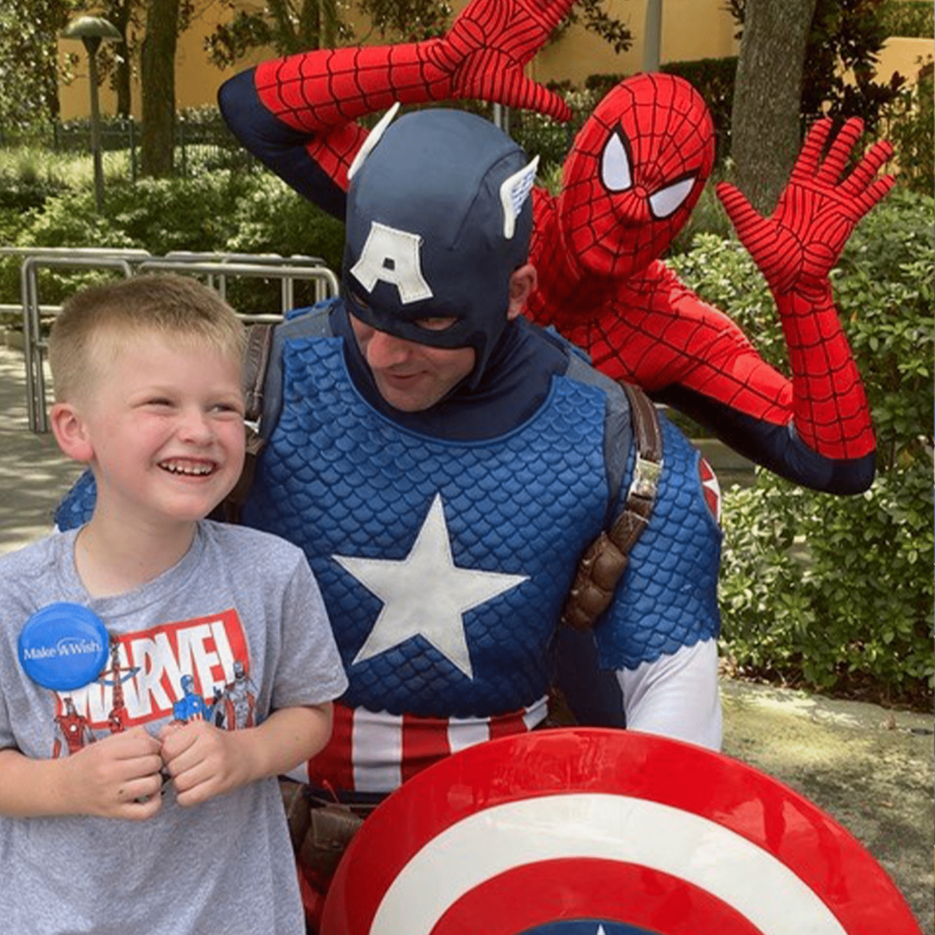 Wish kid poses with Captain America and Spider-Man at Universal Studios