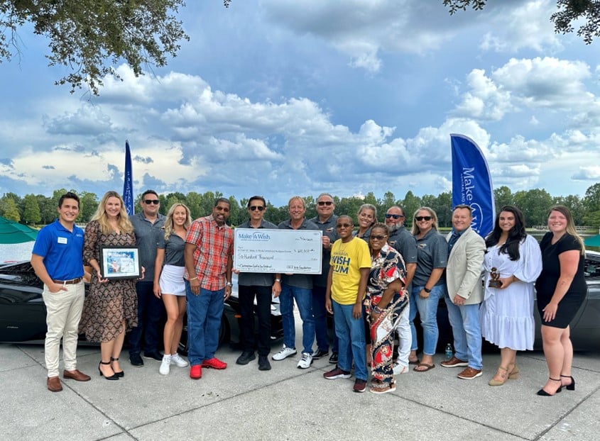 photo of giant check at the Celebration Exotic Car Festival