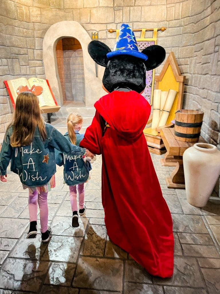 Wish Kids walking with Mickey character at Disney World