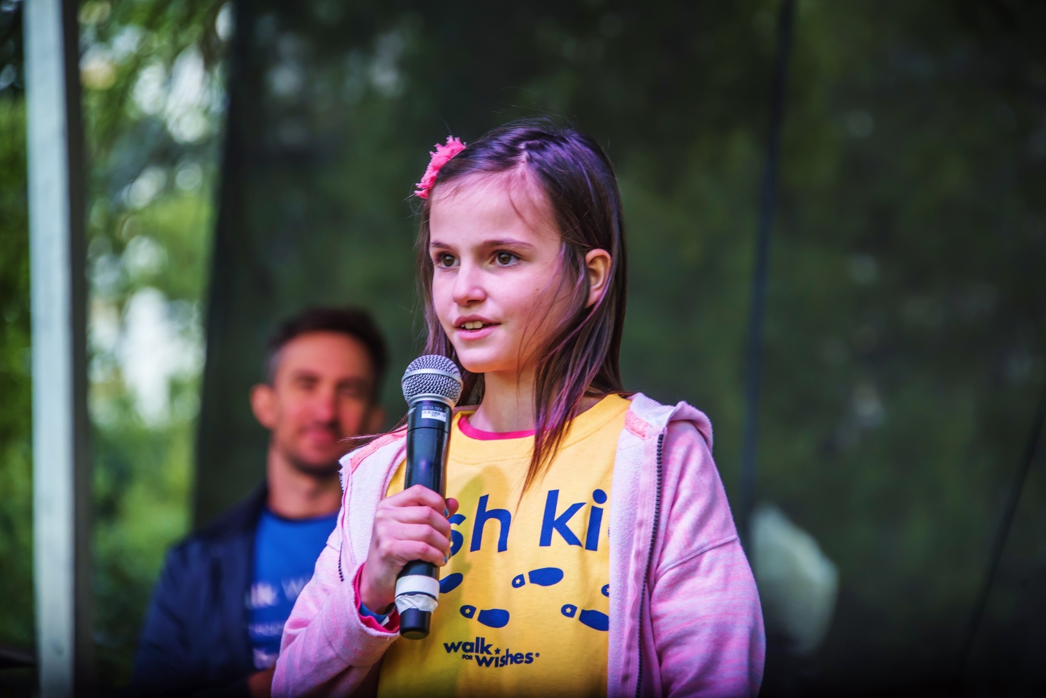 Wish Kid speaking on stage at the Walk For Wishes