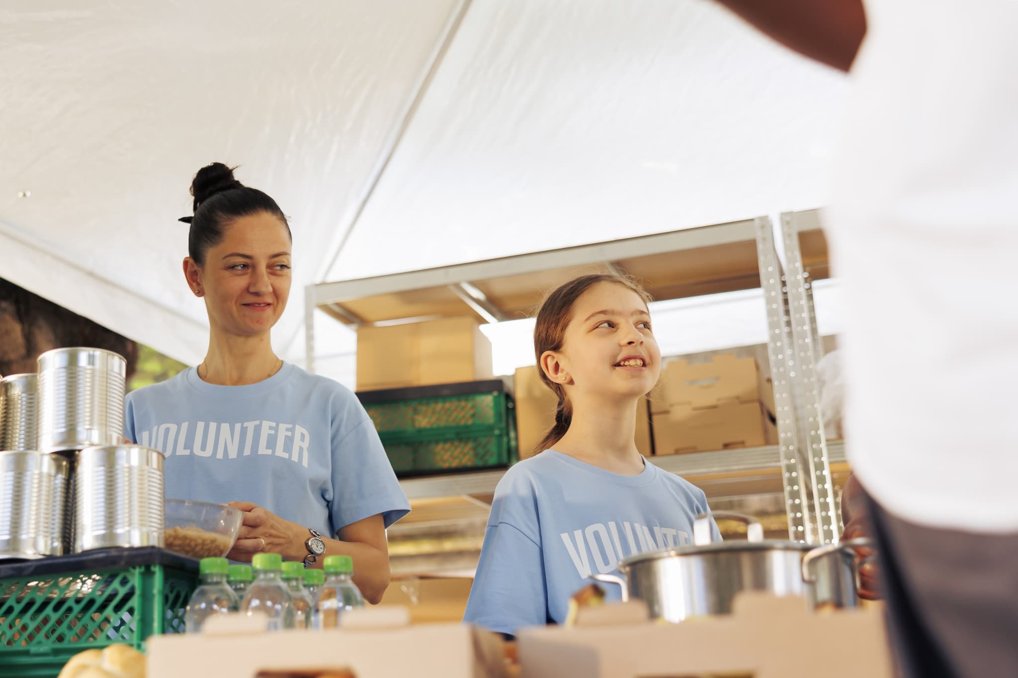 mom and daughter volunteering at food drive