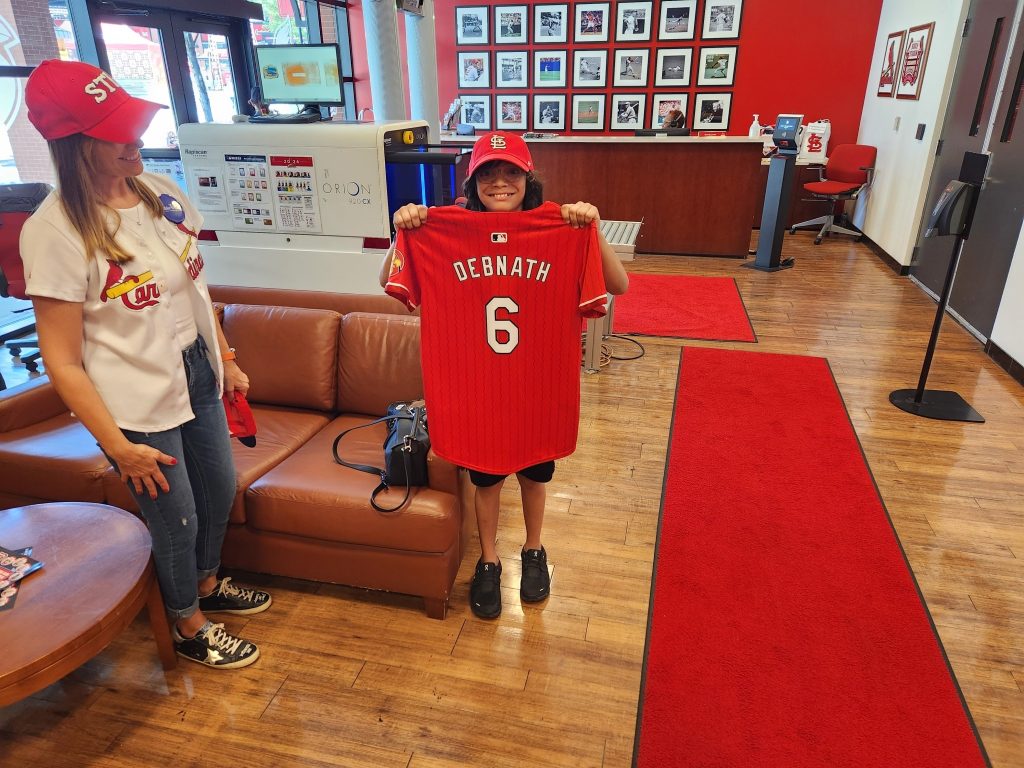 Wish kid Sidney holding baseball jersey