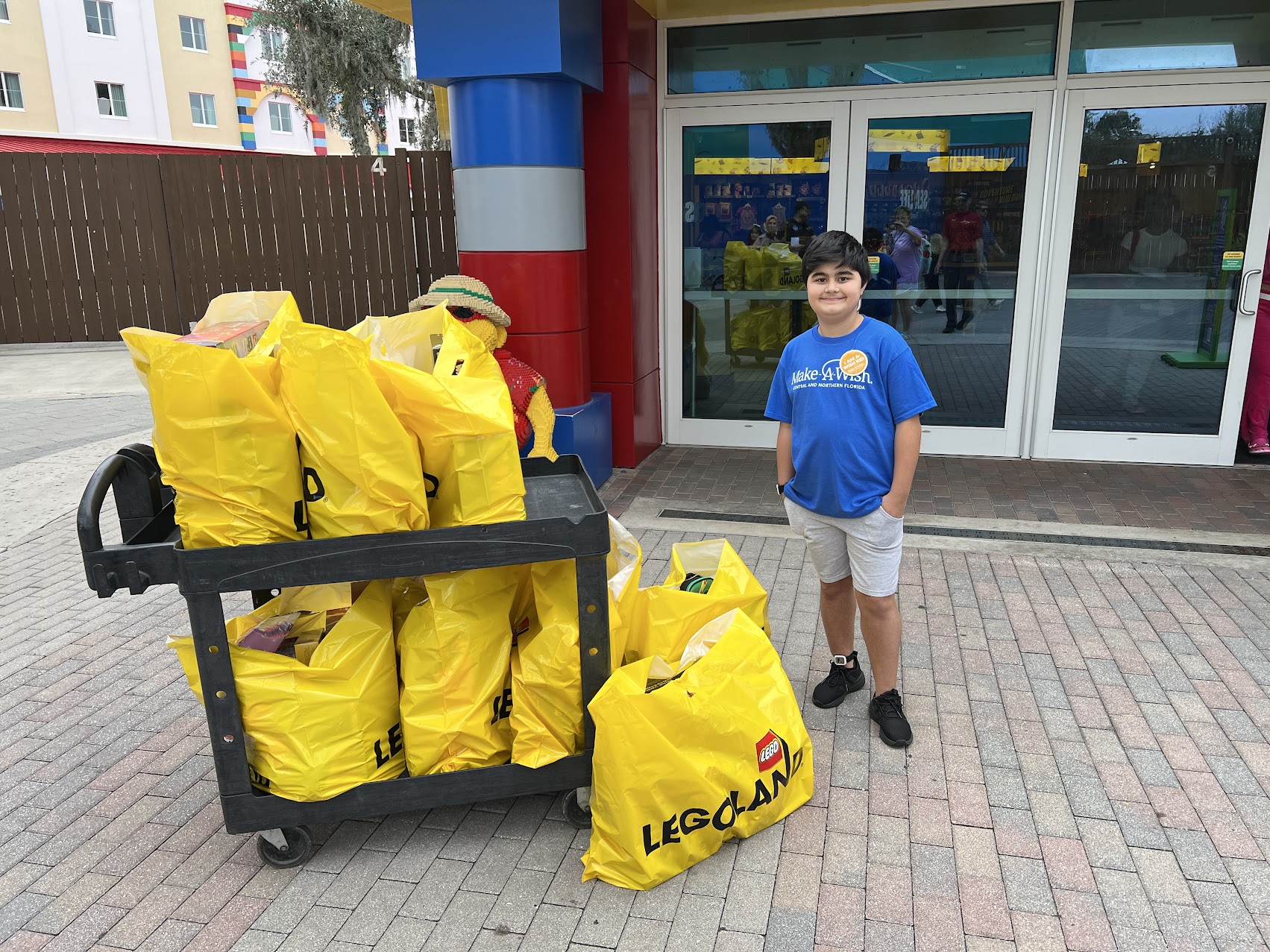 Wish kid Semih with LEGO shopping bags