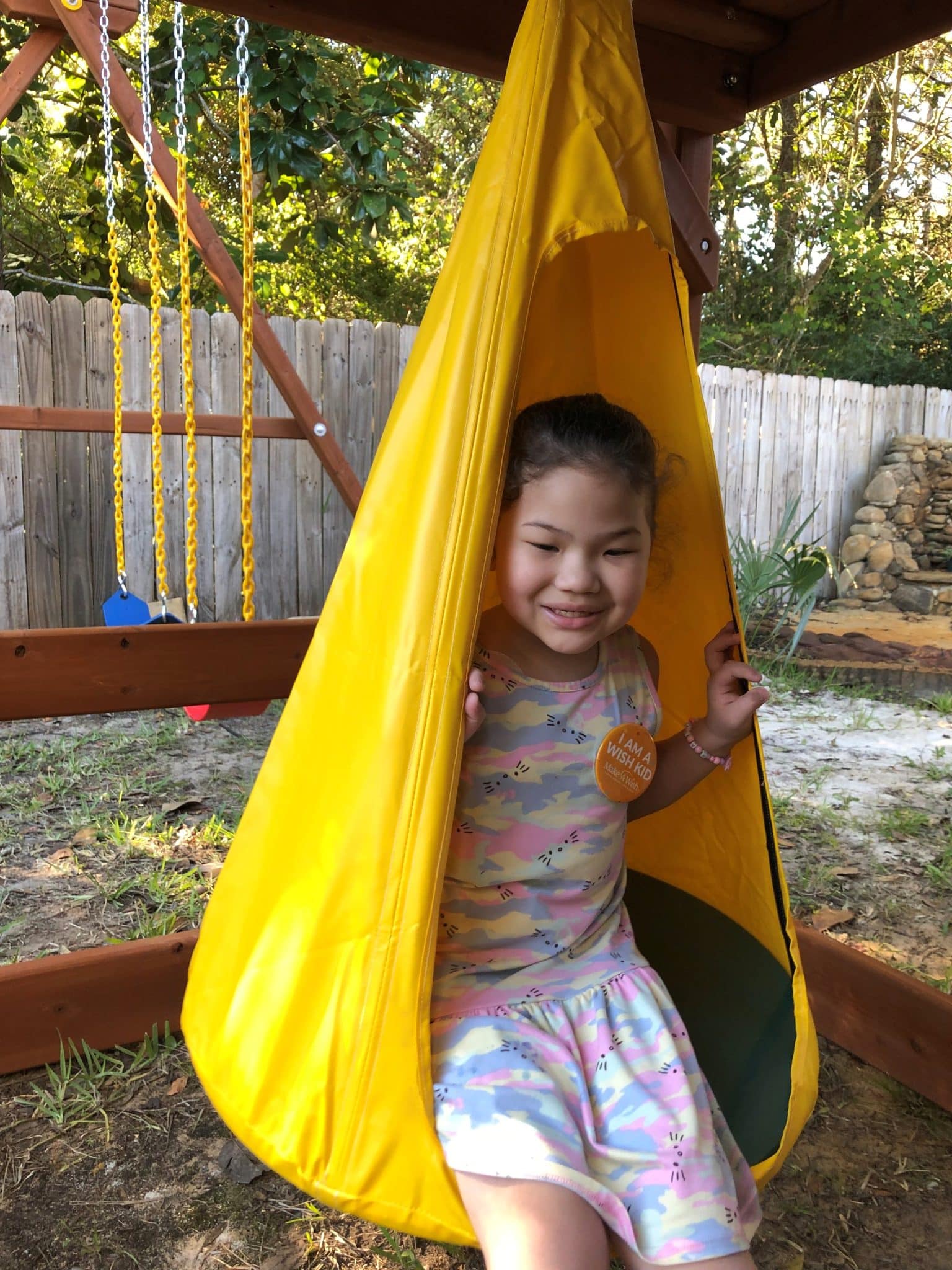Wish Kid Evelyn enjoying her new backyard playset